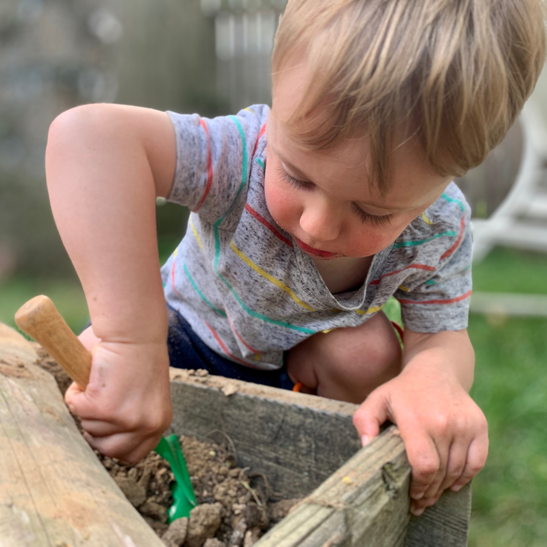 young boy playing in dirt