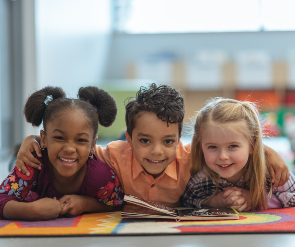 Three young children smiling 