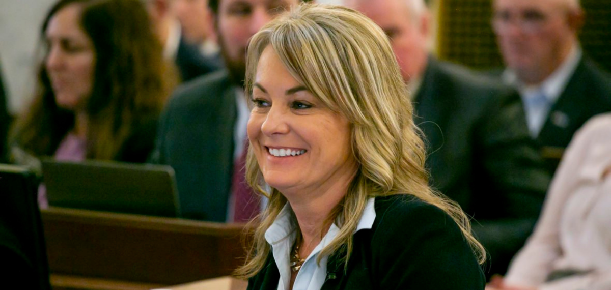 Blond woman in suit smiling