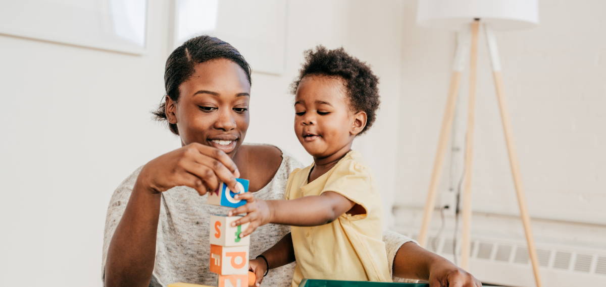 child and woman playing with blocks