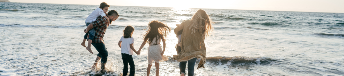 Family playing in the ocean 